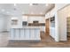Modern kitchen featuring white cabinetry, stainless steel appliances, and a large center island with a sink at 785 Black Palace St, Henderson, NV 89011