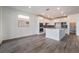 Open kitchen with white cabinets, island, and stainless steel appliances in a modern design at 785 Black Palace St, Henderson, NV 89011