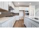 Well-lit kitchen features white cabinets, modern backsplash, stainless steel appliances, and ample counter space at 785 Black Palace St, Henderson, NV 89011