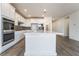 Bright kitchen featuring white cabinetry, stainless steel appliances, and a spacious central island at 785 Black Palace St, Henderson, NV 89011
