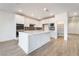 Bright, modern kitchen with white cabinets, a large island, stainless steel appliances, and a walk-in pantry at 785 Black Palace St, Henderson, NV 89011