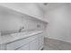 Well-lit laundry room features ample countertop space and modern cabinetry at 785 Black Palace St, Henderson, NV 89011