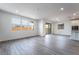 Open-concept living space with wood-look tile floors, natural light and sliding glass doors leading to the backyard at 785 Black Palace St, Henderson, NV 89011