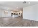 Open-concept kitchen and living space with wood-look floors, recessed lighting, and plenty of counter space at 785 Black Palace St, Henderson, NV 89011