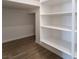 A walk-in pantry features white shelving and wood-look flooring at 785 Black Palace St, Henderson, NV 89011