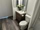 Bathroom features a wooden vanity, a framed mirror, and a pristine white toilet for comfort at 7885 W Flamingo Rd # 2019, Las Vegas, NV 89147