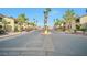 Gated entrance with palm trees, offering security and a grand welcome to the community at 7885 W Flamingo Rd # 2019, Las Vegas, NV 89147