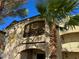 Charming multi-story building with balconies and mature palm trees at 7885 W Flamingo Rd # 2019, Las Vegas, NV 89147