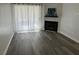 Bright living room featuring fireplace, gray flooring, and sheer curtains for natural light at 7885 W Flamingo Rd # 2019, Las Vegas, NV 89147