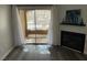 Bright living room with access to the balcony, gray flooring, and cozy fireplace at 7885 W Flamingo Rd # 2019, Las Vegas, NV 89147