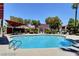 Inviting community pool surrounded by lush landscaping and lounge seating at 7885 W Flamingo Rd # 2019, Las Vegas, NV 89147