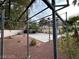 Spacious backyard featuring a workout rig, red rock landscaping, and ample space for outdoor activities at 8138 Yucca Springs Dr, Las Vegas, NV 89129