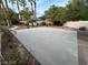 Concrete backyard featuring a basketball hoop and well-maintained landscaping at 8138 Yucca Springs Dr, Las Vegas, NV 89129
