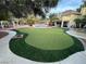 Expansive backyard with putting green, pool, and mature landscaping perfect for entertaining at 8138 Yucca Springs Dr, Las Vegas, NV 89129