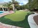 Beautifully landscaped backyard with a putting green and inground pool at 8138 Yucca Springs Dr, Las Vegas, NV 89129