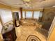 Bright bathroom featuring a jacuzzi bathtub with tile surround, a glass-enclosed shower and tile flooring at 8138 Yucca Springs Dr, Las Vegas, NV 89129