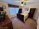 Comfortable bedroom with ceiling fan, built-in bookcase, and large window provides plenty of natural light at 8138 Yucca Springs Dr, Las Vegas, NV 89129