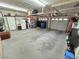 Spacious two car garage with overhead storage, shelving and a refrigerator, providing ample space for parking and projects at 8138 Yucca Springs Dr, Las Vegas, NV 89129