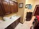 Well-lit laundry room with white sink, custom wood cabinets, and views to other rooms and the laundry machine at 8138 Yucca Springs Dr, Las Vegas, NV 89129