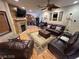 Comfortable living room featuring a fireplace, hardwood floors, and leather furniture at 8138 Yucca Springs Dr, Las Vegas, NV 89129