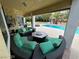 Inviting outdoor patio with an outdoor lounge area and views of the pool and tropical landscaping at 8138 Yucca Springs Dr, Las Vegas, NV 89129