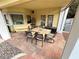 Inviting outdoor patio with an outdoor dining table and stone paver flooring, surrounded by colorful plants at 8138 Yucca Springs Dr, Las Vegas, NV 89129