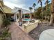 Covered patio area with elegant outdoor furniture and a built-in grill, perfect for gatherings at 8138 Yucca Springs Dr, Las Vegas, NV 89129