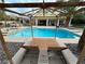 Backyard oasis featuring a refreshing pool and spa, framed by a wooden lounge area at 8138 Yucca Springs Dr, Las Vegas, NV 89129