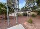 Backyard featuring workout equipment, desert landscaping, and mature trees at 8138 Yucca Springs Dr, Las Vegas, NV 89129