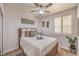Inviting bedroom featuring neutral colors, a comfortable bed, and a ceiling fan at 8247 Oasis Bloom St, North Las Vegas, NV 89085