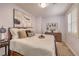 Comfortable bedroom features neutral decor, soft lighting, and a cozy king-sized bed at 8247 Oasis Bloom St, North Las Vegas, NV 89085
