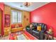 Fun bonus room, painted in the 49ers colors, including a seating area for watching sports at 8247 Oasis Bloom St, North Las Vegas, NV 89085