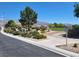 Scenic community park with lush greenery, mature trees, picnic benches and views of distant mountains at 8247 Oasis Bloom St, North Las Vegas, NV 89085