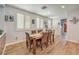 Dining room with wood-look floors, plantation shutters, and modern decor at 8247 Oasis Bloom St, North Las Vegas, NV 89085