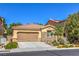 Attractive single-story residence featuring a two-car garage, xeriscaping, and stone accents at 8247 Oasis Bloom St, North Las Vegas, NV 89085