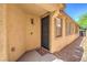 A cozy front porch featuring a secure metal front door and views of the side yard at 8247 Oasis Bloom St, North Las Vegas, NV 89085