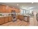 Well-lit kitchen with stainless appliances, granite countertops, and view to the living room at 8247 Oasis Bloom St, North Las Vegas, NV 89085