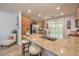 Kitchen with stainless appliances, granite counters, island seating, and backyard access at 8247 Oasis Bloom St, North Las Vegas, NV 89085