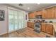 Cozy kitchen featuring stainless steel appliances, tile backsplash, and sliding door to backyard at 8247 Oasis Bloom St, North Las Vegas, NV 89085