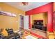 Bright living room with wood floors, red accent wall, and fan lighting at 8247 Oasis Bloom St, North Las Vegas, NV 89085