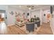 Spacious living room featuring wood-look floors, comfortable seating, and open layout at 8247 Oasis Bloom St, North Las Vegas, NV 89085