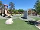 Community playground with slides, climbing wall, and soft landing surface, offering fun for children at 8247 Oasis Bloom St, North Las Vegas, NV 89085