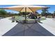 Community playground under a sun shade, with seating area, trash cans, slides and play equipment at 8247 Oasis Bloom St, North Las Vegas, NV 89085