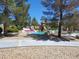 Vibrant park featuring a modern playground, colorful surfacing, and lush landscaping for to play and explore at 8247 Oasis Bloom St, North Las Vegas, NV 89085
