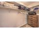 Functional walk-in closet provides shelving, hanging space, and a wooden dresser for storage at 8247 Oasis Bloom St, North Las Vegas, NV 89085