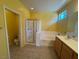 Bright bathroom with a walk-in shower, separate bathtub and a double sink vanity with wood cabinets at 8325 Aspen Village St, Las Vegas, NV 89113