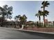 Community pool area with palm trees and green landscaping and building in the background at 8325 Aspen Village St, Las Vegas, NV 89113