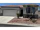 Charming single-story home with a well-manicured desert landscape and a convenient two-car garage at 8325 Aspen Village St, Las Vegas, NV 89113