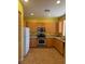 Eat-in kitchen equipped with stainless steel appliances, light wood cabinets, and tile flooring at 8325 Aspen Village St, Las Vegas, NV 89113