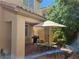 Backyard patio with a table, chairs, BBQ grill, and lush greenery creating a relaxing outdoor space at 8345 Mozley Park St, Las Vegas, NV 89113